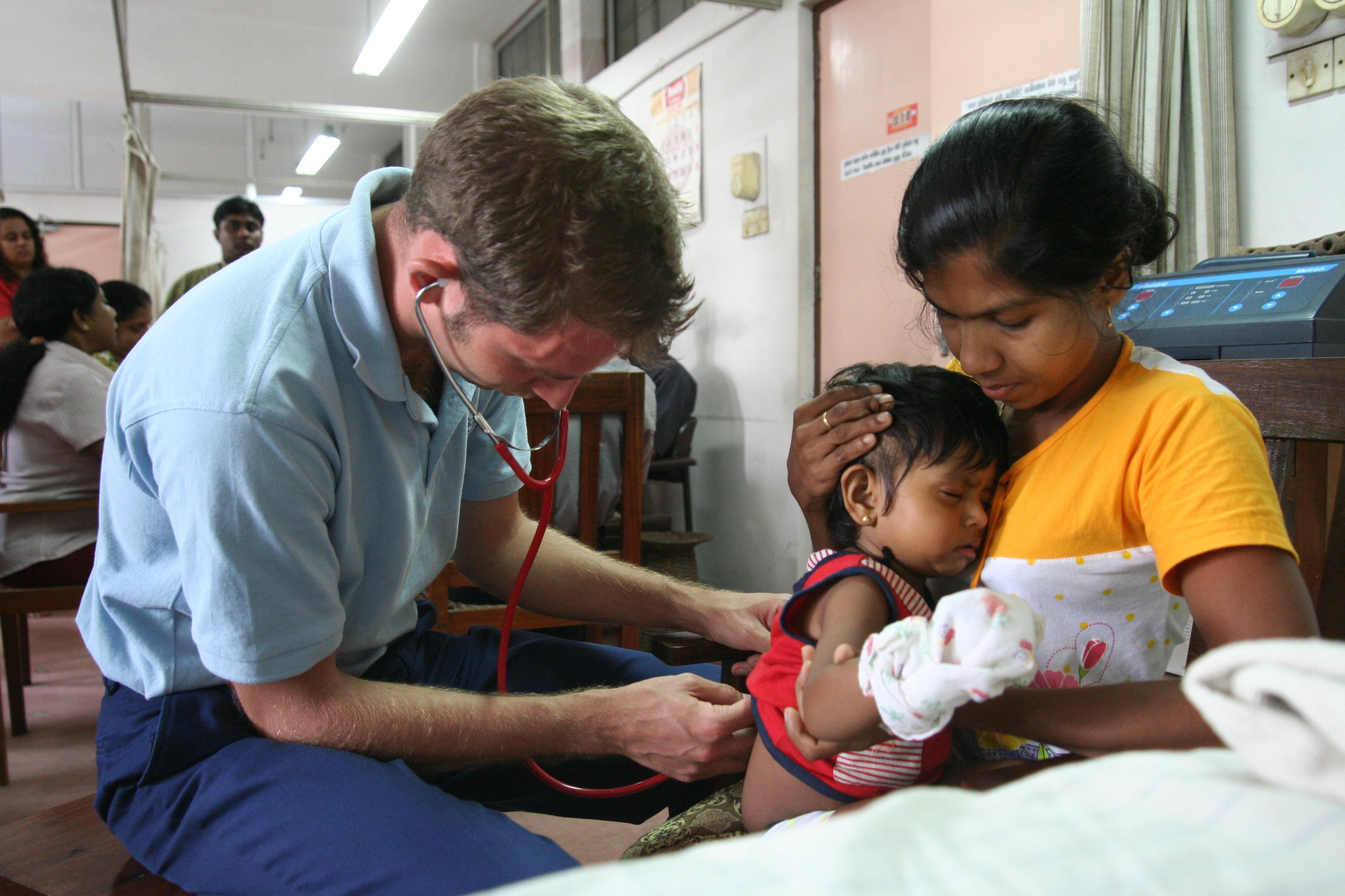 Projects Abroad intern performs a check up on a baby as part of his midwifery internship in Sri Lanka. Projects Abroad male intern is seen performing a check up on a baby as part of his midwifery internship in Sri Lanka.